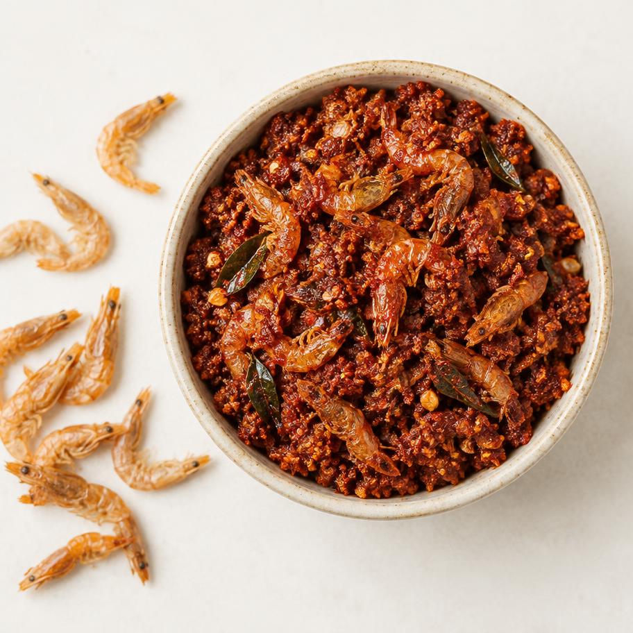 Dried prawns pickle with whole dried prawns beside a ceramic bowl