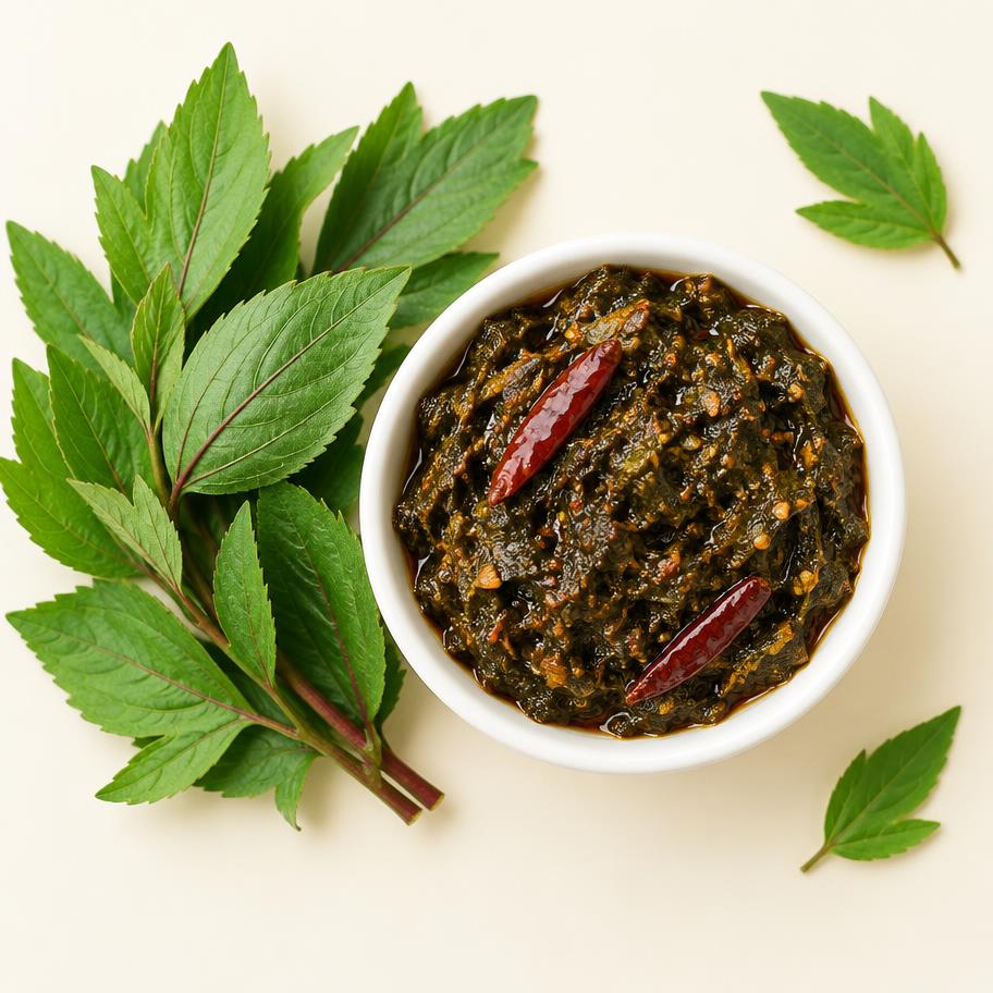 Gongura sorrel leaf pickle in a bowl with fresh gongura leaves